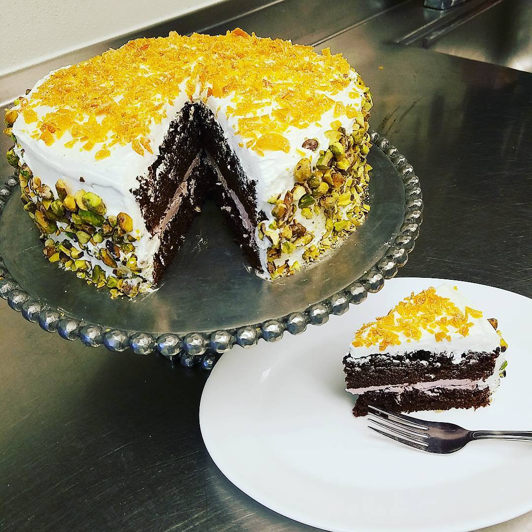 Va Bene Instagram Photo: @vabenecaffe The first day of spring calls for a bright, sunny cake. Chocolate cake, orange buttercream, Parfait Amour buttercream filled, topped off with candied orange peel. Roasted pistachio. #delizioso #thatsitalian #pistachio #candiedorangepeel #parfaitamour #orangechocolate #buttercream